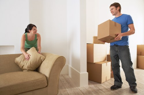 Household furniture being moved through a period property with narrow access